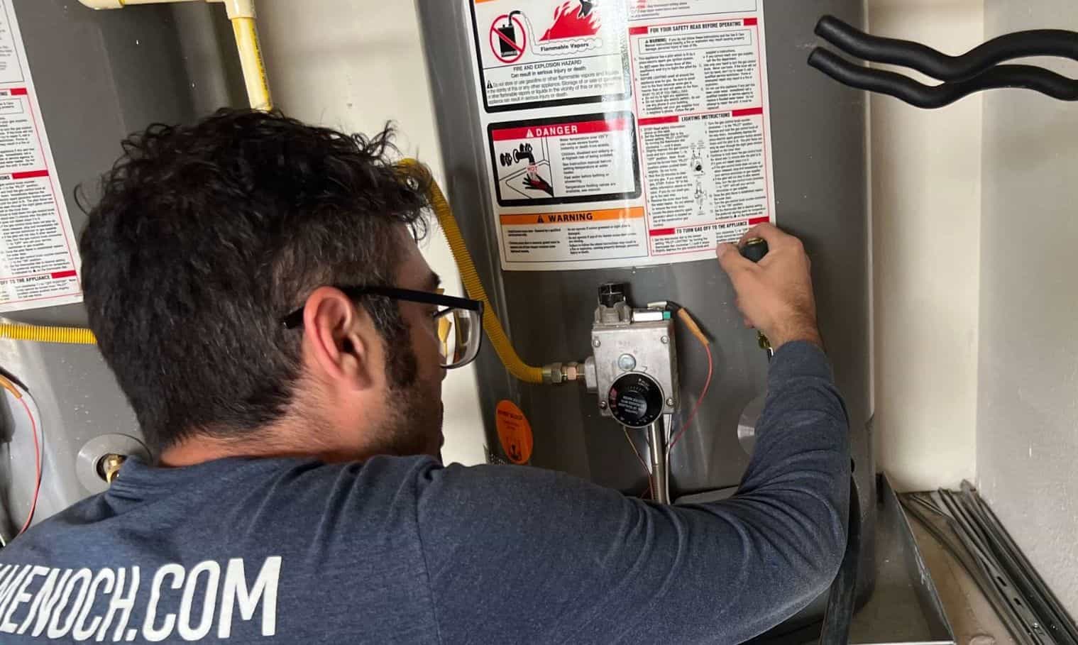technician installing a water heater